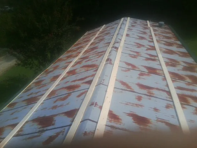 Rusted metal roof panels with new wood purlins before replacement — Storm Damage Roof Repair in Tell City by Roofing Brothers